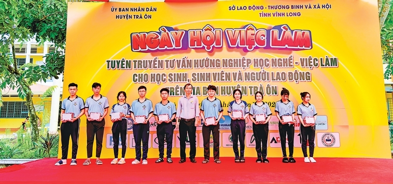 Ông Huỳnh Tuấn Kiệt- Phó Giám đốc Trung tâm Dịch vụ việc làm tỉnh, đại diện trao quà cho học sinh vượt khó học giỏi tại Ngày hội Việc làm huyện Trà Ôn năm 2024, hồi giữa tháng 8.